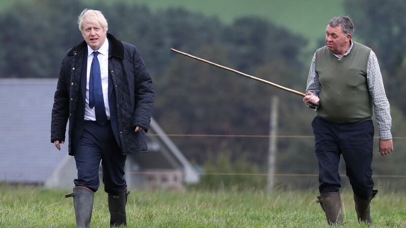 Boris Johnson is shown around by farmer Peter Watson at Darnford Farm. Photograph: Andrew Milligan/AFP/Getty