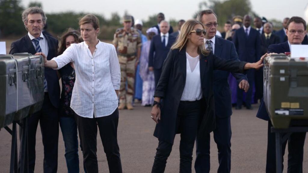 Colleagues of Radio France Internationale journalists Ghislaine Dupont and Claude Verlon pay tribute to their remains at the airport of Bamako during a ceremony yesterday. Photograph: Philippe Desmazes/AFP