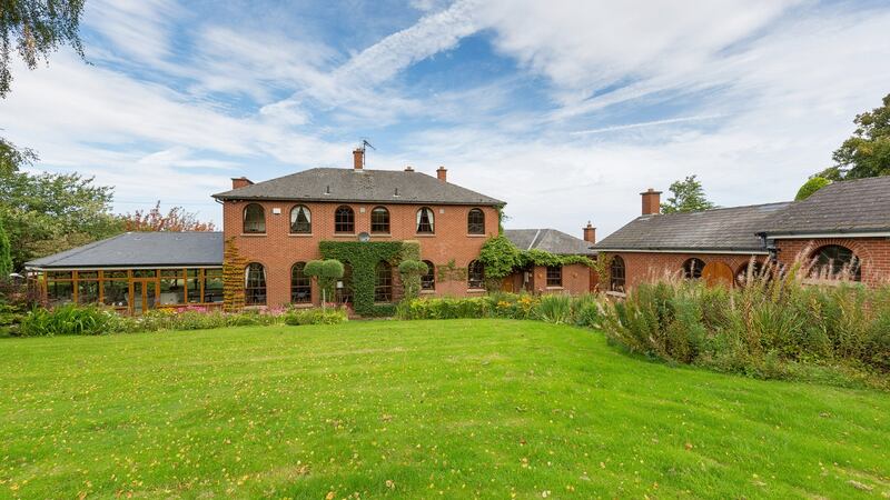 Newgrange from the back garden. The stables (right) are finished in red brick.