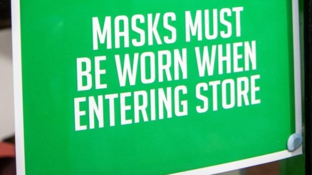 Sign advising customers at a store in Belfast to wear masks. Photograph: Liam McBurney/PA Wire