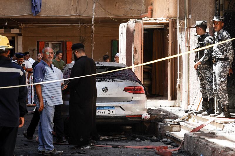 A Coptic priest is pictured outside the Abu Sifin church in the Imbaba neighbourhood west of the Nile river. Photograph: KHALED DESOUKI/AFP via Getty Images