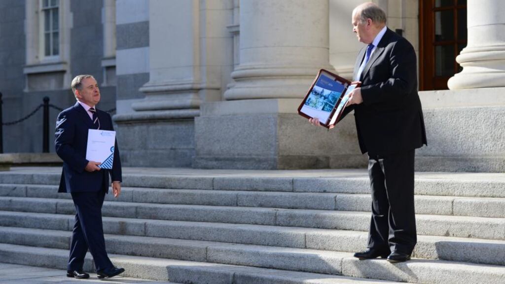 Minister for Public Expenditure Brendan Howlin and Minister for Finance Michael Noonan present the budget last year: Ireland’s consistent outperformance of budgetary targets has been rewarded by the financial markets. Photograph: Bryan O’Brien
