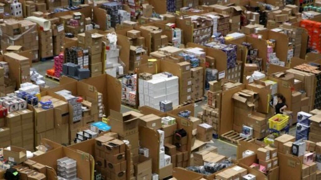 Workers collect customer orders during Black Friday deals week at an Amazon fulfilment centre in Hemel Hempstead, England.