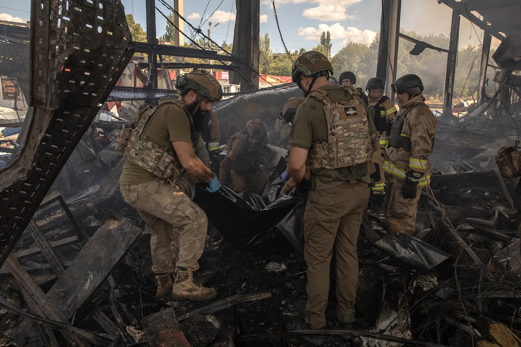 Ukrainian military and emergency rescue personnel recover a body from the rubble of a supermarket destroyed in a Russian strike in Kostyantynivka last month. Photograph: Roman Pilipey/AFP/Getty