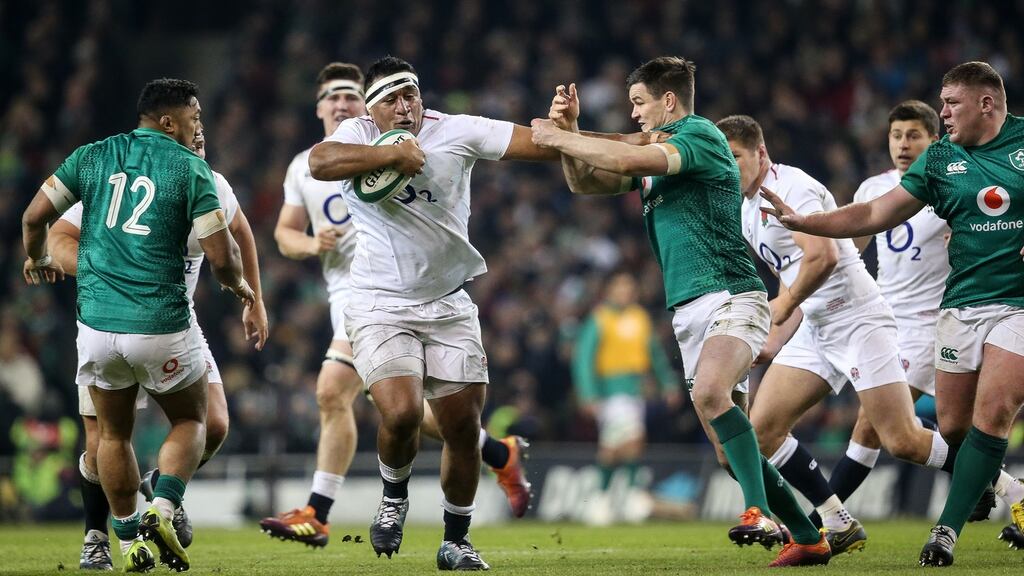 England’s Mako Vunipola tries to shake off an attempted tackle from Ireland’s Johnny Sexton during the Six Nations match at the Aviva stadium. Photograph: Gary Carr/Inpho