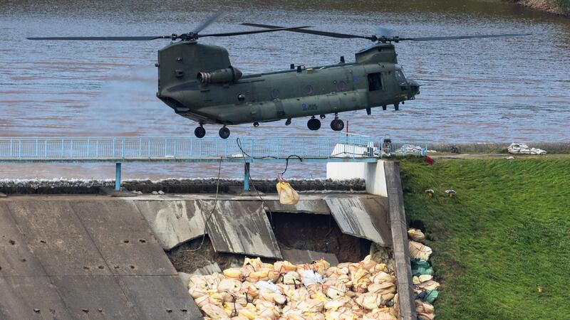 An RAF Chinook helicopter drops sand bags on to the damaged dam at Toddbrook reservoir in Whaley Bridge, Derbyshire. Photograph: Vickie Flores/EPA