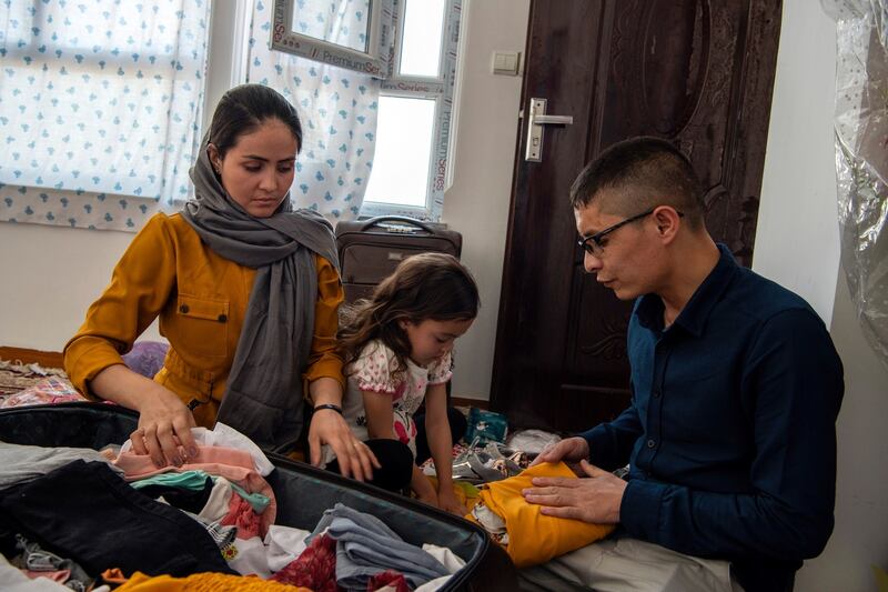 Afghan Air Force Maj Naiem Asadi, his wife, Rahima, and their daughter, Zainab, pack their bags in Kabul on May 31st. Photograph: Kiana Hayeri/The New York Times
