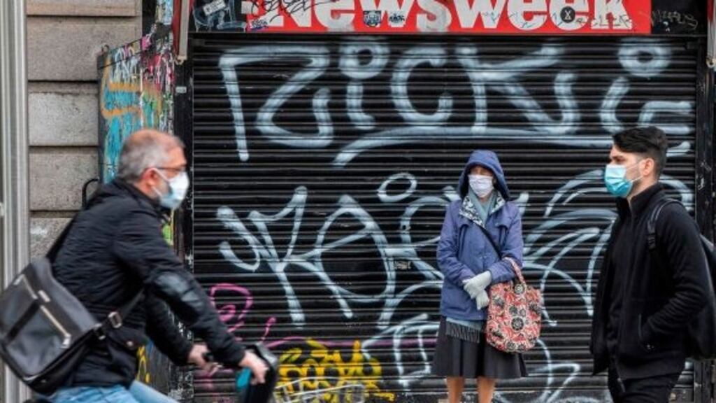 Pedestrians and cyclists wear protective face masks as they travel through Dublin city centre. Photograph: Paul Faith/AFP