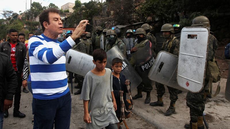 Opposition candidate Salvador Nasralla, films with a mobile phone soldiers during a protest against the re-election of Honduras’ President Juan Orlando Hernandez. Photograph: Jorge Cabrera/Reuters