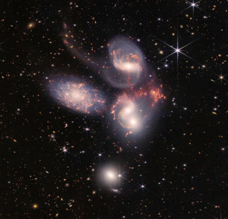 The James Webb Space Telescope reveals Stephans Quintet, a visual grouping of five galaxies, in a new light on July 12, 2022 in space. This enormous mosaic is Webb's largest image to date, covering about one-fifth of the Moons diameter. The information from Webb provides new insights into how galactic interactions may have driven galaxy evolution in the early universe. (Photo by NASA, ESA, CSA, and STScI via Getty Images)