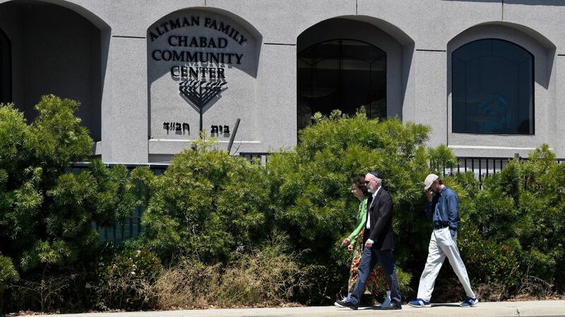 Synagogue members walk outside of the Chabad of Poway synagogue in Poway, California. Photograph: Denis Poroy/AP