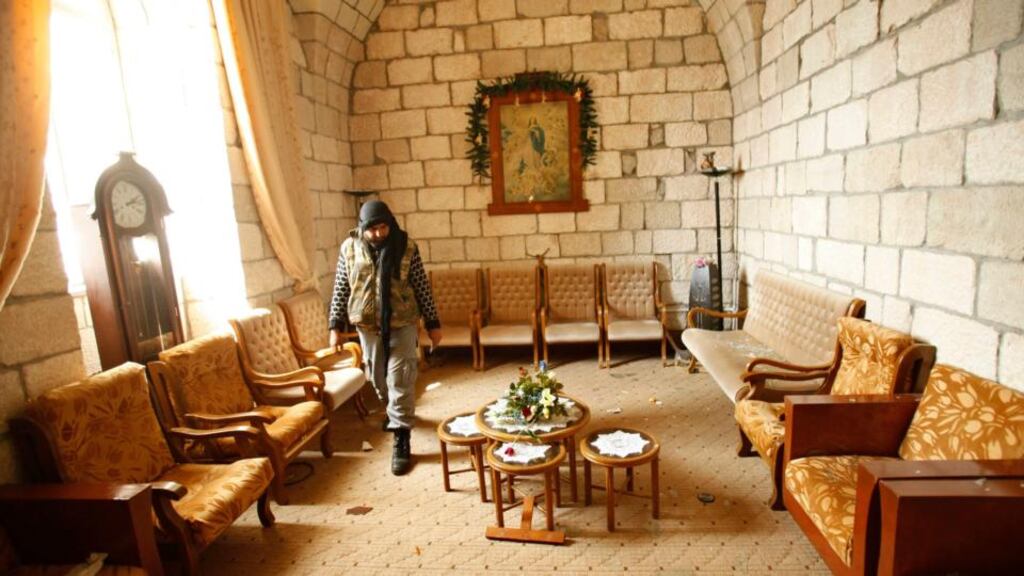 A rebel fighter from the Islamic Front in a church in the Armenian Christian town of Kessab. Photograph: Ammar Abdullah/Reuters