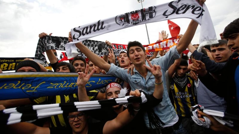 Fans of Besiktas (black-white), Galatasaray (yellow-red) and Fenerbahce (yellow-blue) pose during an anti-government protest at Taksim Square in central Istanbul. Days of anti-government protest in Turkey have achieved one feat that has eluded the authorities for years: uniting the fiercely rival and sometimes violent supporters of Istanbul’s “Big Three” football clubs. Besiktas, Galatasaray and Fenerbahce fans have come together in new-found solidarity against Prime Minister Tayyip Erdogan’s government. Photograph: Murad Sezer/Reuters