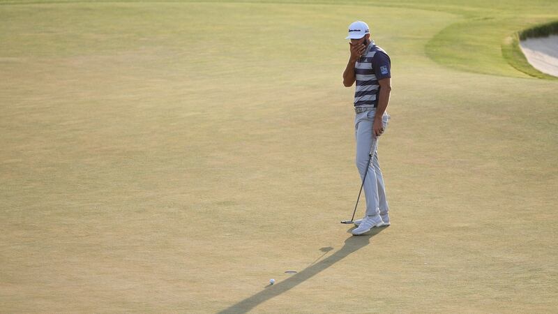 Dustin Johnson reacts to his missed putt on the 18th. Photo: Ross Kinnaird/Getty Images