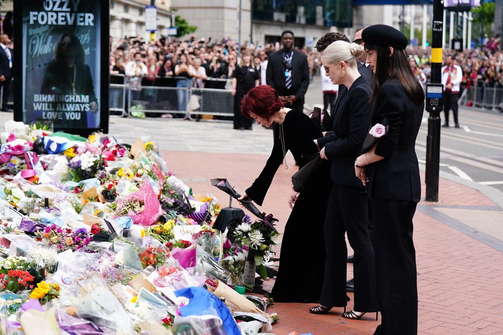 Sharon Osbourne, with family members, lays flowers at the Black Sabbath Bridge bench on Broad Street in Birmingham in memory of Black Sabbath frontman Ozzy Osbourne. Photograph:: Jacob King/PA Wire