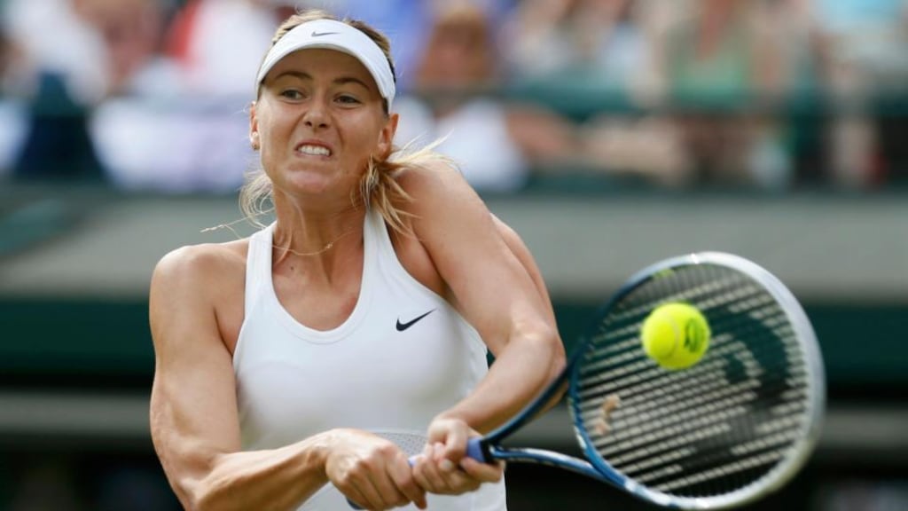 Maria Sharapova of Russia hits a return to Samantha Murray of Britain on her way to a 6-1, 6-0 victory at the Wimbledon Tennis Championships, in London. Photograph: Reuters