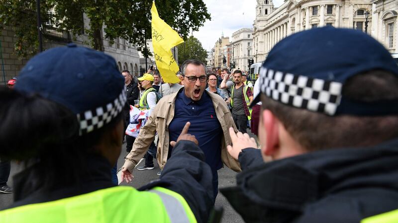 Police confront a demonstrator during an anti-government protest calling for the Boris Johnson’s resignation, outside Downing Street in central London. Photograph: Daniel Leal-Olivas/AFP/Getty