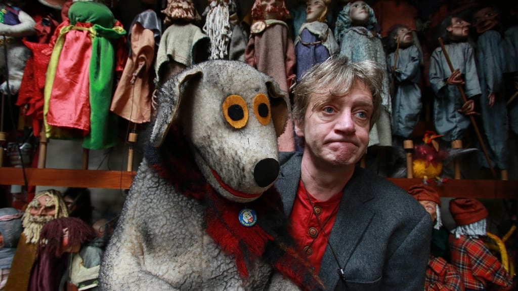 Liam Lambert in the fire-damaged area of the Lambert Puppet Theatre with the puppet Judge. Photograph: Nick Bradshaw