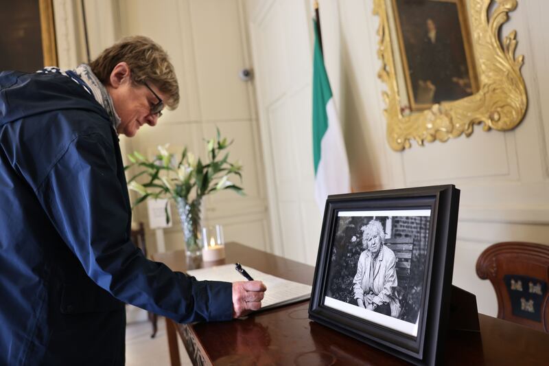 Eileen Scanlan from Dundrum, Dublin, signs the book of condolences for Nell McCafferty in the Mansion House on Thursday. Photograph: Dara Mac Dónaill/The Irish Times