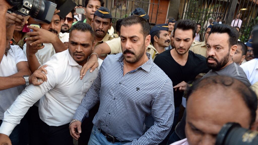 Bollywood actor Salman Khan (centre) walks from the high court in Mumbai on Thursday, after being acquitted of culpable homicide over the death of a homeless man in a hit-and-run incident 13 years ago. Photograph: Indranil Mukherjee/AFP/Getty Images