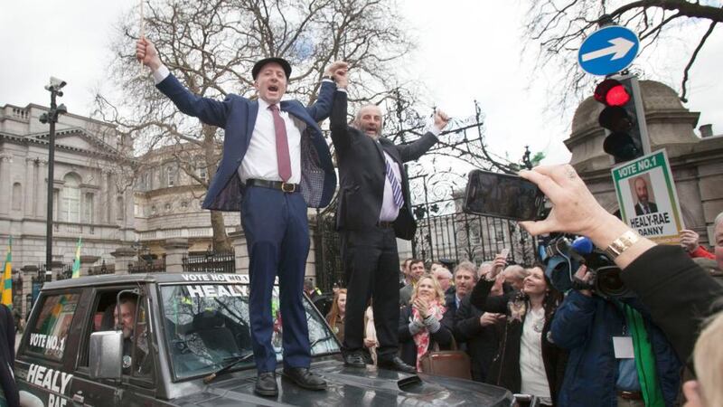 Expert self-publicists: Michael and Danny Healy-Rae step-dancing on the bonnet of a mucky jeep outside Leinster House. Photograph: Alan Betson