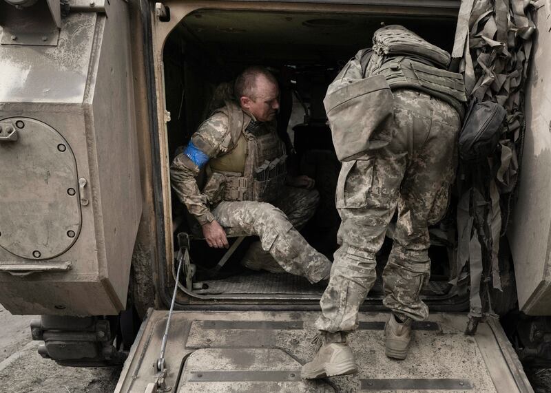 Soldiers moving a patient from an armored vehicle to a stabilization point in Ukraine. Photograph: Emile Ducke/The New York Times
Ducke/The New York Times)