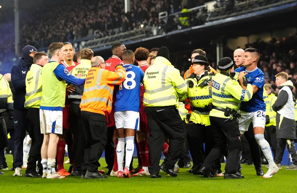 Everton's Carlos Alcaraz (right) appeared to be held by a police officer after the final whistle. Photograph: Nick Potts/PA Wire