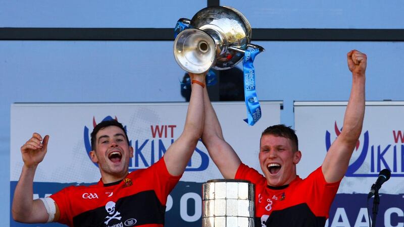 UCC joint captains Eoghan Murphy and Conor Browne lift the Fitzgibbon Cup trophy after victory against Mary Immaculate College at Waterford Institute of Technology. Photograph: Ken Sutton/Inpho