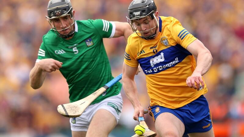 Clare’s Tony Kelly makes a break past Diarmaid Byrnes of Limerick during the Munbster round-robin game at Cusack Park. Photograph: Tom Maher/Inpho
