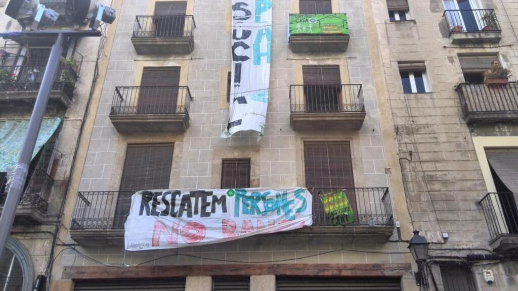 The building at Plaça del Pedró in Barcelona that has been taken over by squatters. The original lock on the building’s front door has been ripped out and replaced, and each studio-apartment door bears the marks of a cutter where the lock has been changed. Photograph: Mary Boland