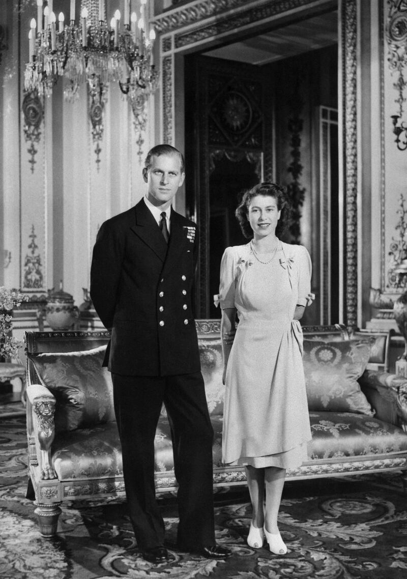 (FILES) In this file photo taken on July 09, 1947 Princess Elizabeth (L) (future Queen Elizabeth II) and her Fiance Philip Mountbatten (R) (the future Duke of Edinburgh) pose in Buckingham Palace in London on July 9, 1947 in London, the day their engagement was officially announced. - Queen Elizabeth II's 99-year-old husband Prince Philip, who was recently hospitalised and underwent a successful heart procedure, died on April 9, 2021, Buckingham Palace announced. (Photo by - / AFP) (Photo by -/AFP via Getty Images)