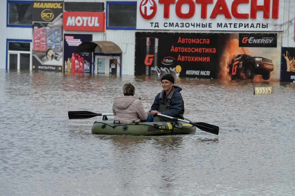 People leave the flooded residential area of Orenburg in Russia on Friday. Photograph: EPA