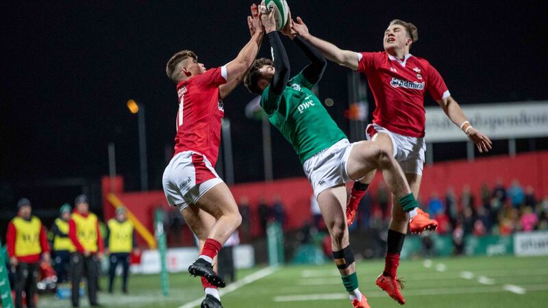 Ireland’s Andrew Smith challenges Ewan Rosser and Ioan Lloyd of Wales. Photo: Morgan Treacy/Inpho