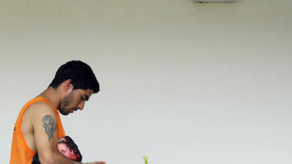 Luis Suarez leaves the team training centre in Natal last week. Photograph: EPA
