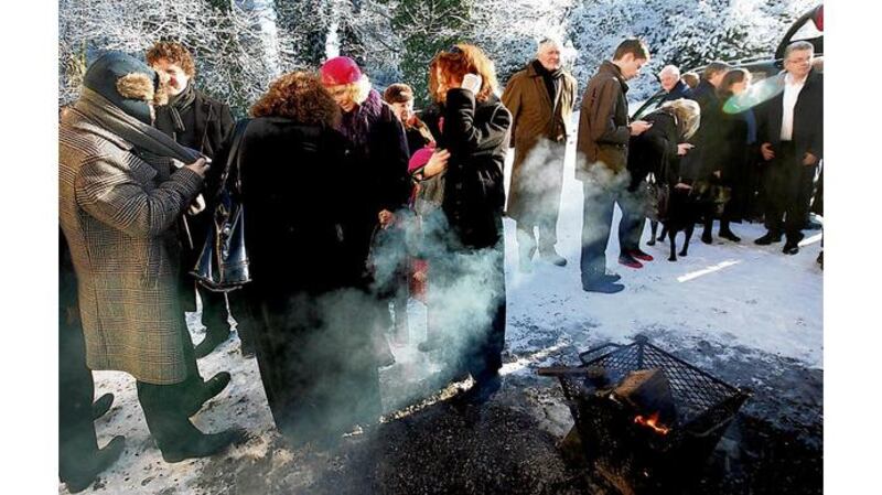 Mourners gather outside the home of Justin Keating for his funeral at Ballymore Eustace, Co Kildare.