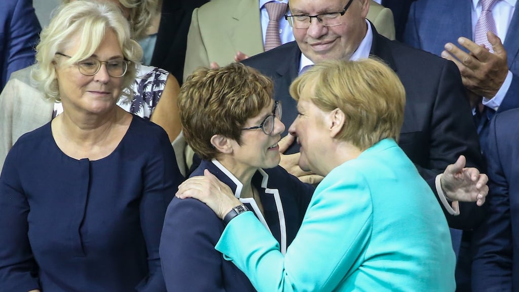 Germany’s new defence minister Annegret Kramp-Karrenbauer is congratulated by chancellor Angela Merkel after she took her official oath of office during a special session of the Bundestag on Wednesday. Photograph: Wolfgang Kumm/AFP/Getty Images