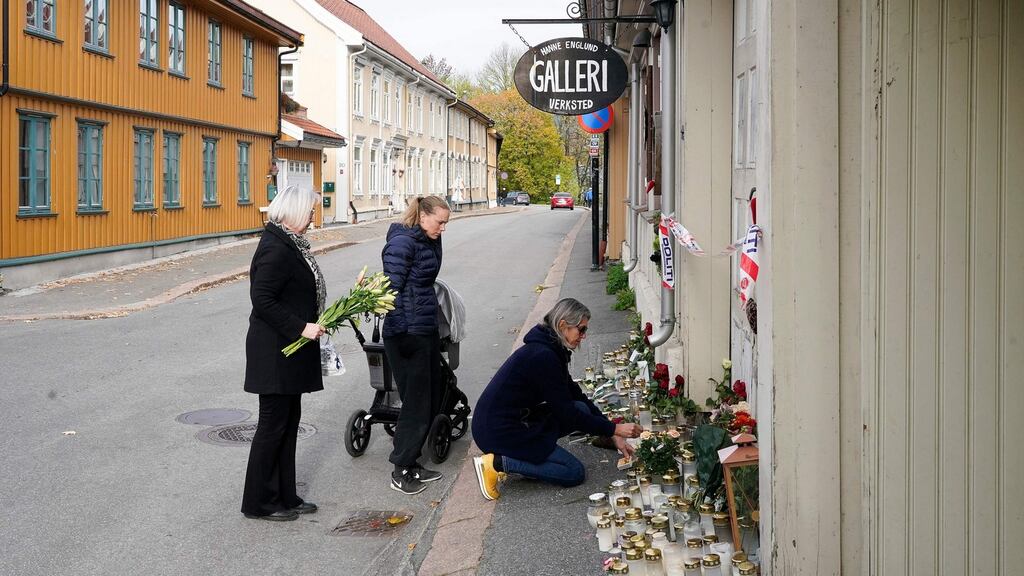 Three students of artist Hanne Merethe Englund, one of five victims of a stabbing attack on October 13th, lay flowers in front of her house in Kongsberg, Norway. Photograph: Terje Bendiksby/NTB/AFP via Getty Images