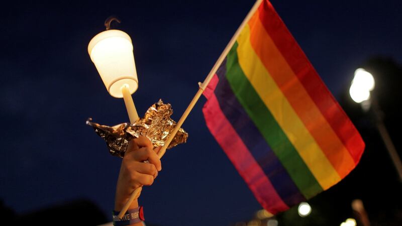 A rainbow flag held aloft during a vigil after the worst mass shooting in US history at a gay nightclub in Orlando, Florida. Photograph: Joshua Roberts/Reuters