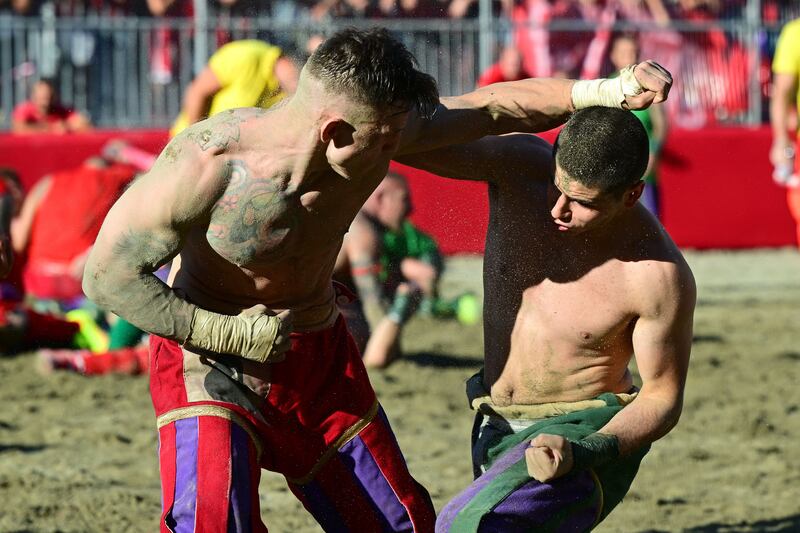 A Red team player fights with a Green team one during the Calcio Storico Fiorentino. Photograph: Vincenzo Pinto/AFP via Getty