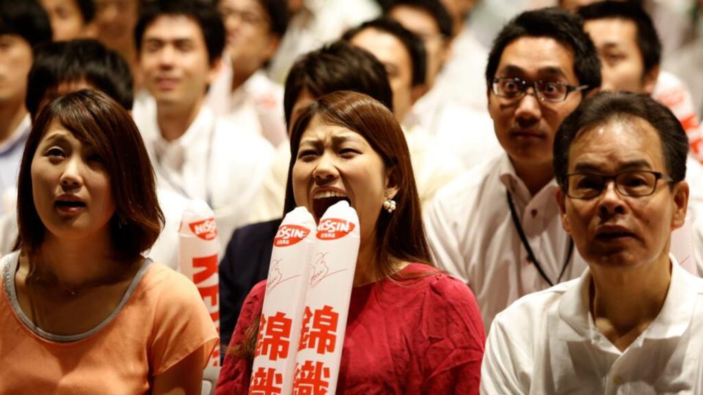 Employees of Japanese noodle maker Nissin Foods Holdings, which sponsors Kei Nishikori, watch the final of the US Open. Photograph: Yuya Shino/Reuters