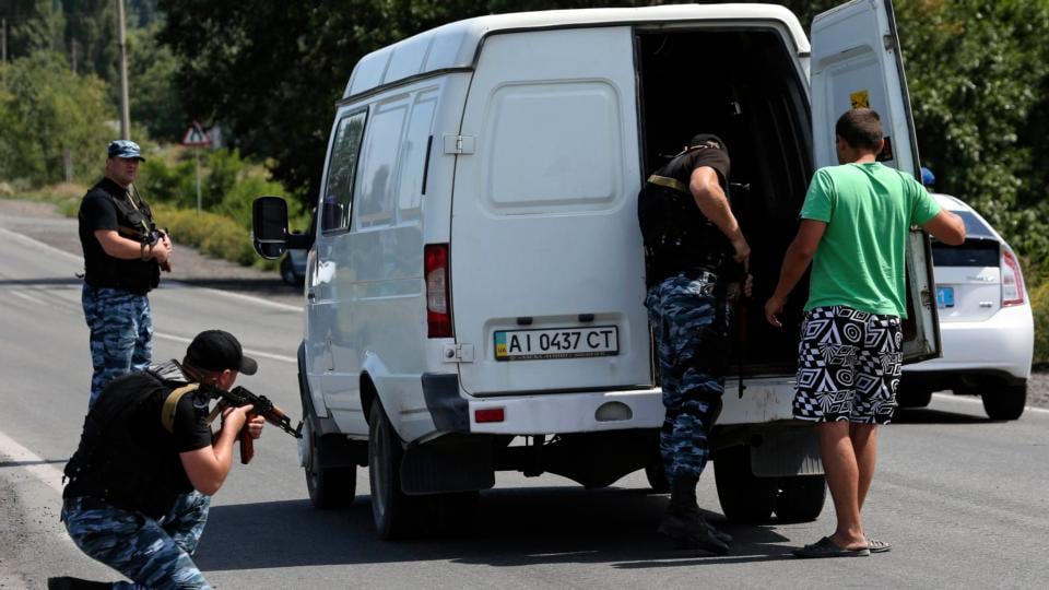 Armed pro-Russian separatists inspect a van as they stand guard on the suburbs of Shakhtarsk, Donetsk region. Photograph: Sergei Karpukhin/Reuters