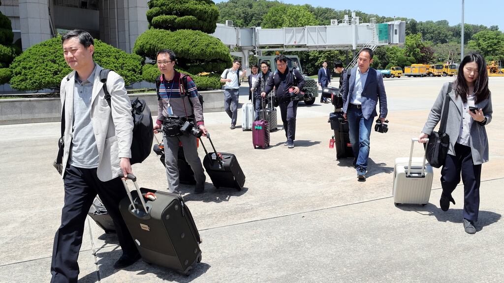 South Korean journalists head to an aircraft at Seoul Airport on Wednesday from where they were to fly to North Korea to witness the dismantlement of the North’s key nuclear test site. Photograph: EPA