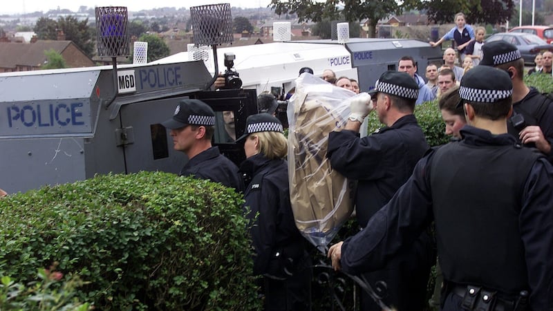 Northern Ireland police officers remove bags of unknown materials from a house during a raid related to the arrest of Denis Donaldson in 2002. Photograph: REUTERS/Paul McErlane