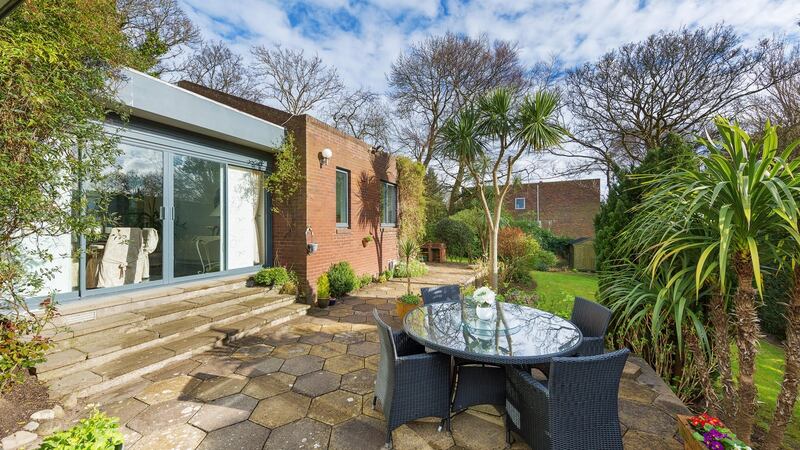 Nearly all the rooms have floor-to-ceiling windows, and a lot of them open on to the patio in the wide back garden