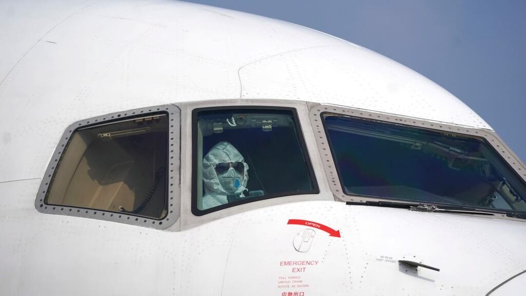 A pilot wearing a protective suit parks a cargo aircraft at Wuhan Tianhe International Airport on Tuesday. Photograph: Cheng Min/Xinhua via AP