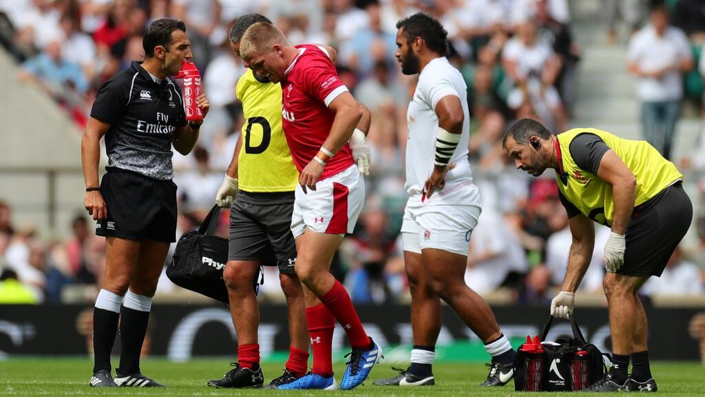 Wales outhalf Gareth Anscombe is helped off the field during the World Cup warm-up against England at Twickenham. Photograph: Dan Mullan/Getty Images