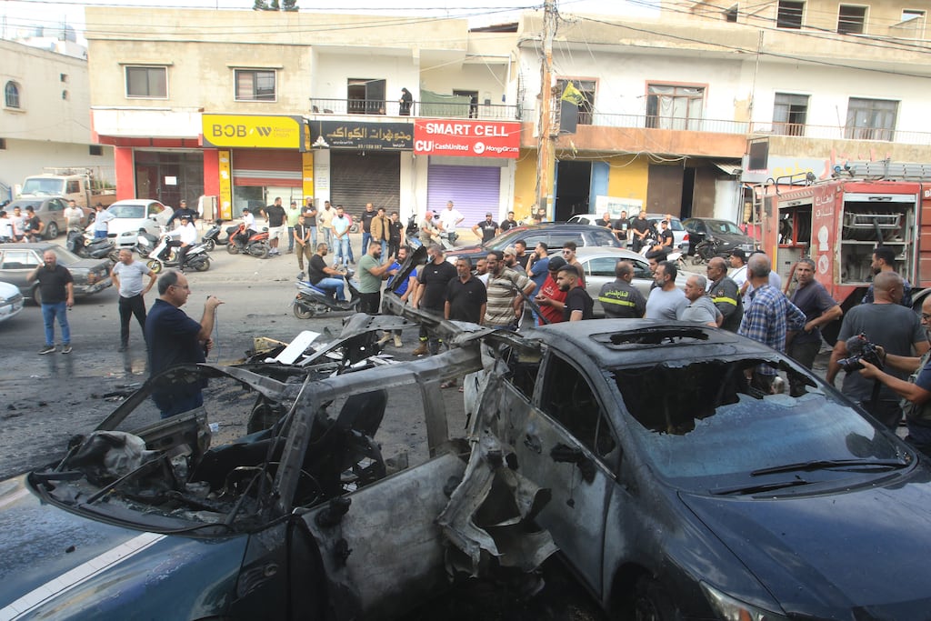 Onlookers survey damage caused by Israeli drone strike in Ad Douwayr, southern Lebanon. Photograph: Mahmoud Zayyat/Getty