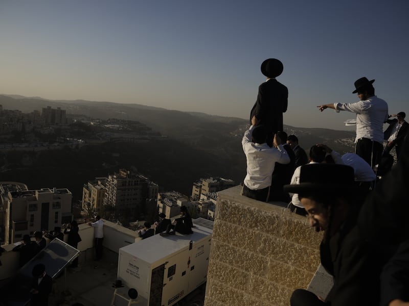 Ultra-Orthodox Israelis stand on rooftops during a protest against military conscription. Photograph: Amir Levy/Getty Images