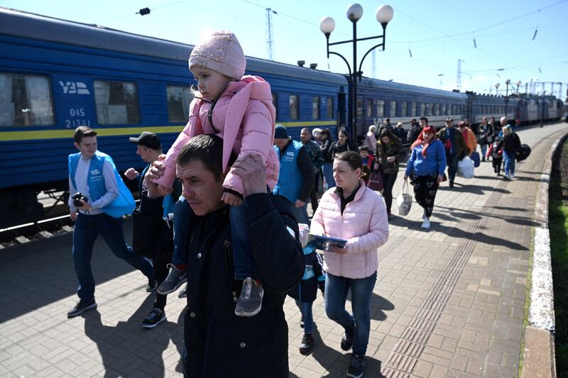Evacuees from Zaporizhzhia region walk on a platform after arriving by an evacuation train at the railway station of the western Ukrainian city of Lviv. Photograph: Yuriy Dyachyshyn/AFP via Getty Images