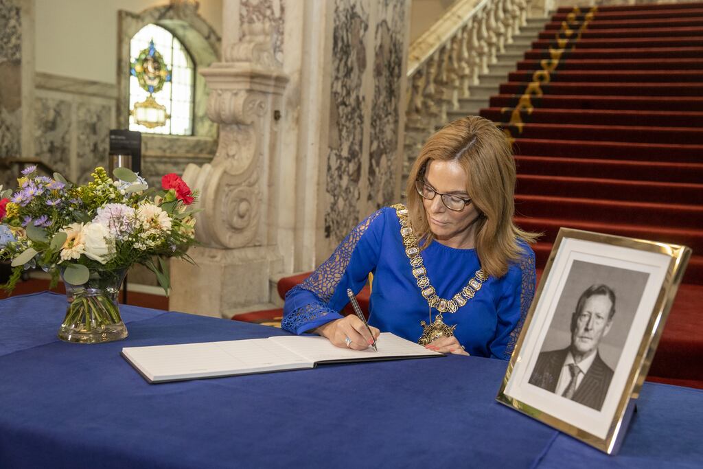Lord Mayor of Belfast Tina Black opens a book of condolence at Belfast City Hall on Tuesday for David Trimble, who died on Monday. Photograph: Liam McBurney/PA